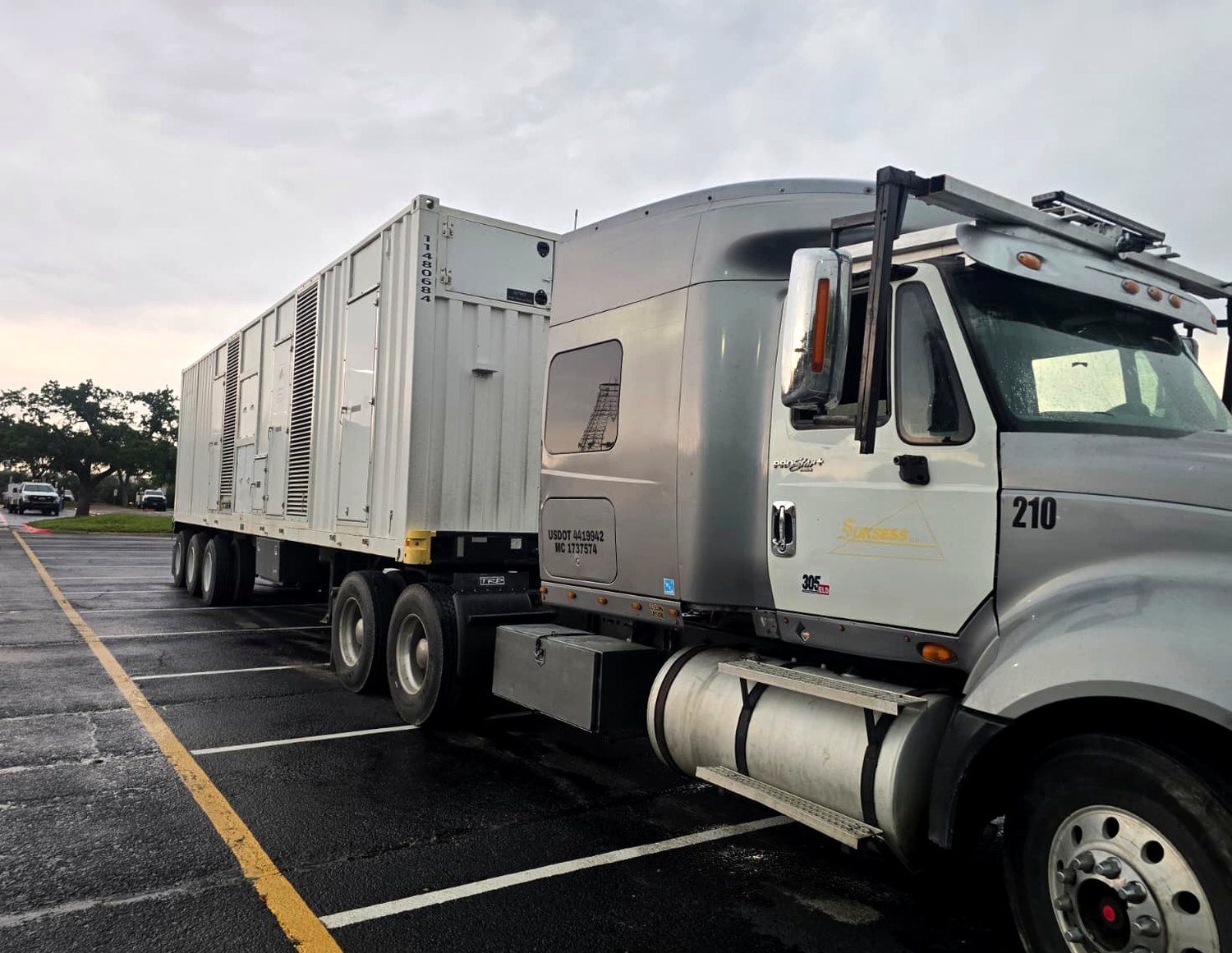 Suksess LLC tractor #210 hauling PowerSecure industrial container - USDOT 4419942, MC 1737574 - Power Only operation, MC authority covers all 48 contiguous states